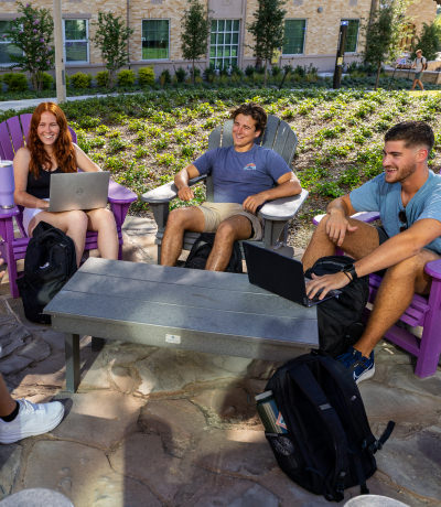 Students relaxing on campus in lawn chairs