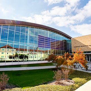 An exterior of the TCU Campus Rec center; other campus buildings are reflected in its shiny surface. An exterior of the TCU Campus Rec center; other campus buildings are reflected in its shiny surface.
