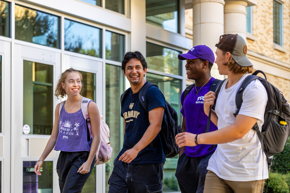 Four students walking on campus
